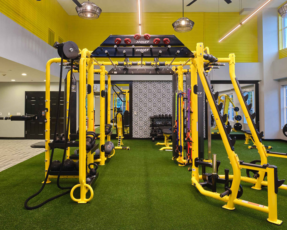 Indoor gym with yellow equipment and astroturf